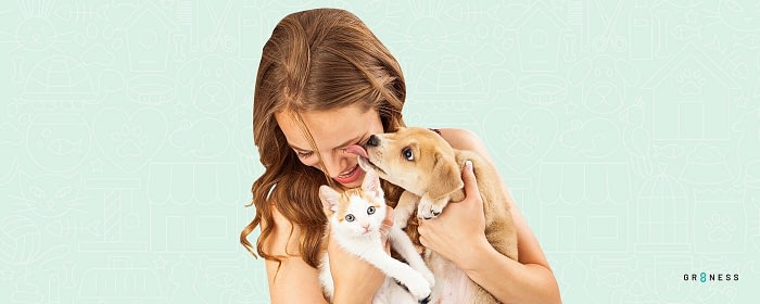 Lady smiling while choosing a dog and a cat as the best pet for apartments