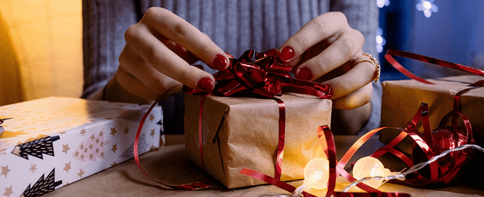 woman wrapping holiday gifts
