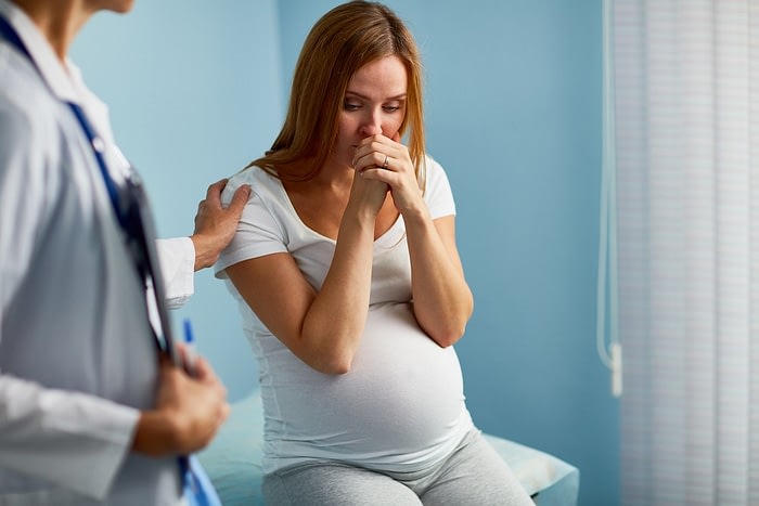 woman receiving pregnancy scare news
