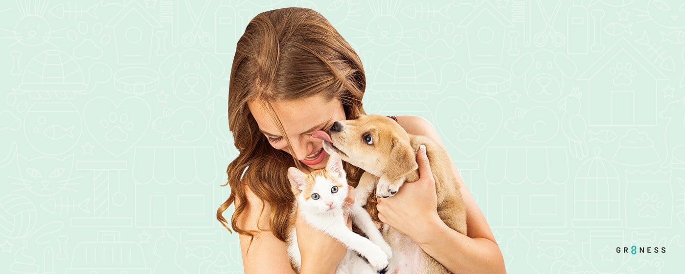 Lady smiling while choosing a dog and a cat as the best pet for apartments