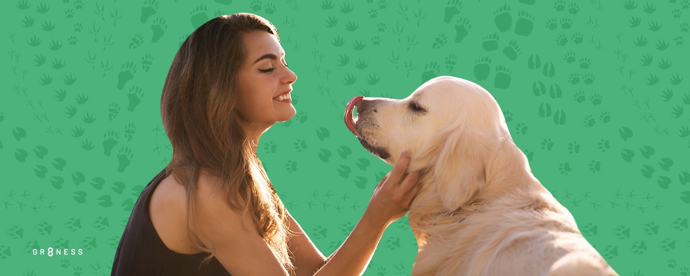 Woman smiling holding dog laughing at her pet personality