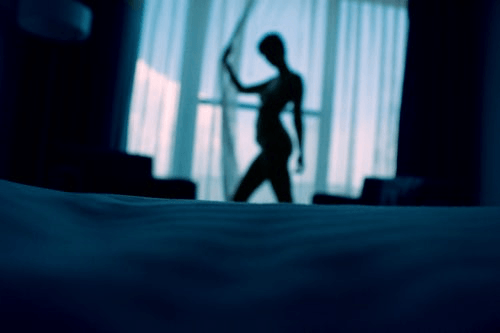 silhouette of woman in front of window