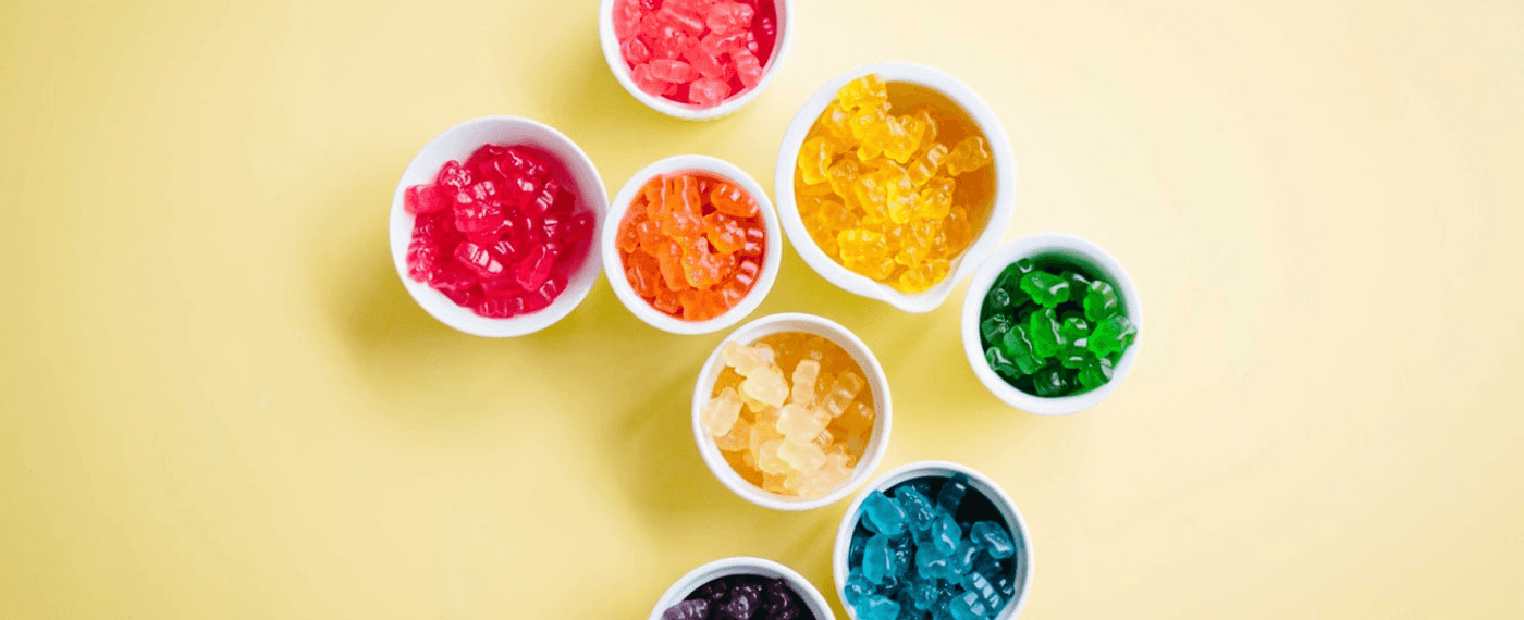 Colorful probiotic gummies in small containers