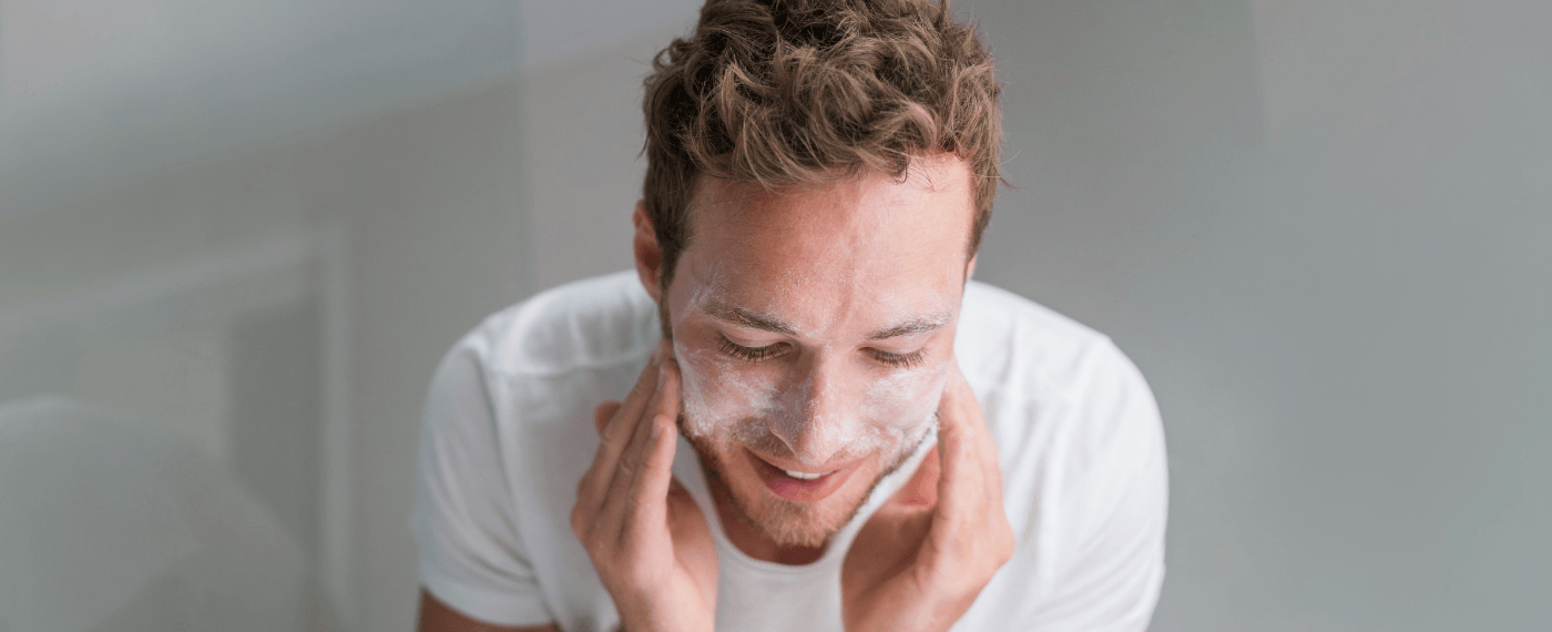 man washing face for his skin care routine