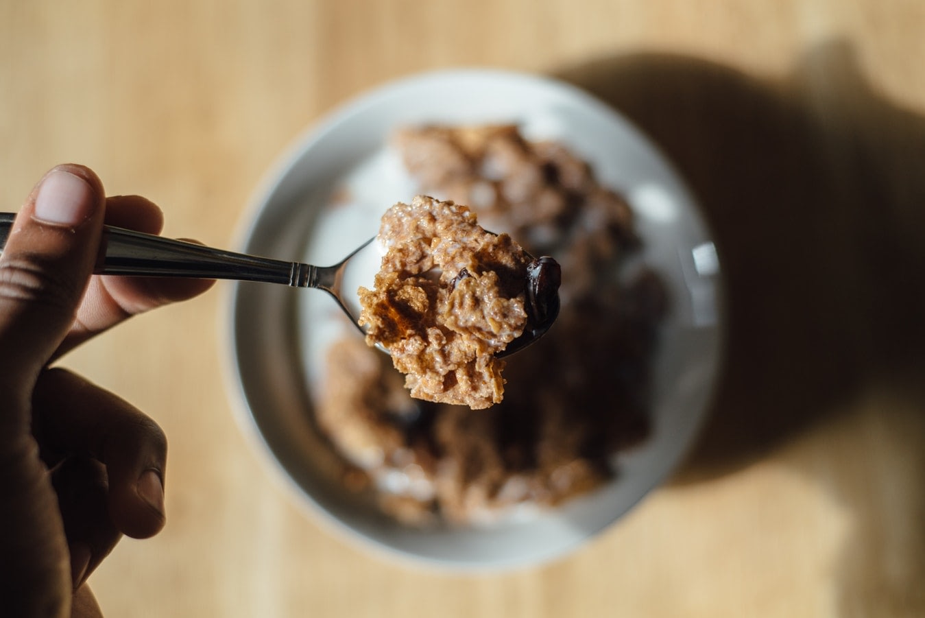 A spoon holding a cbd cereal and milk