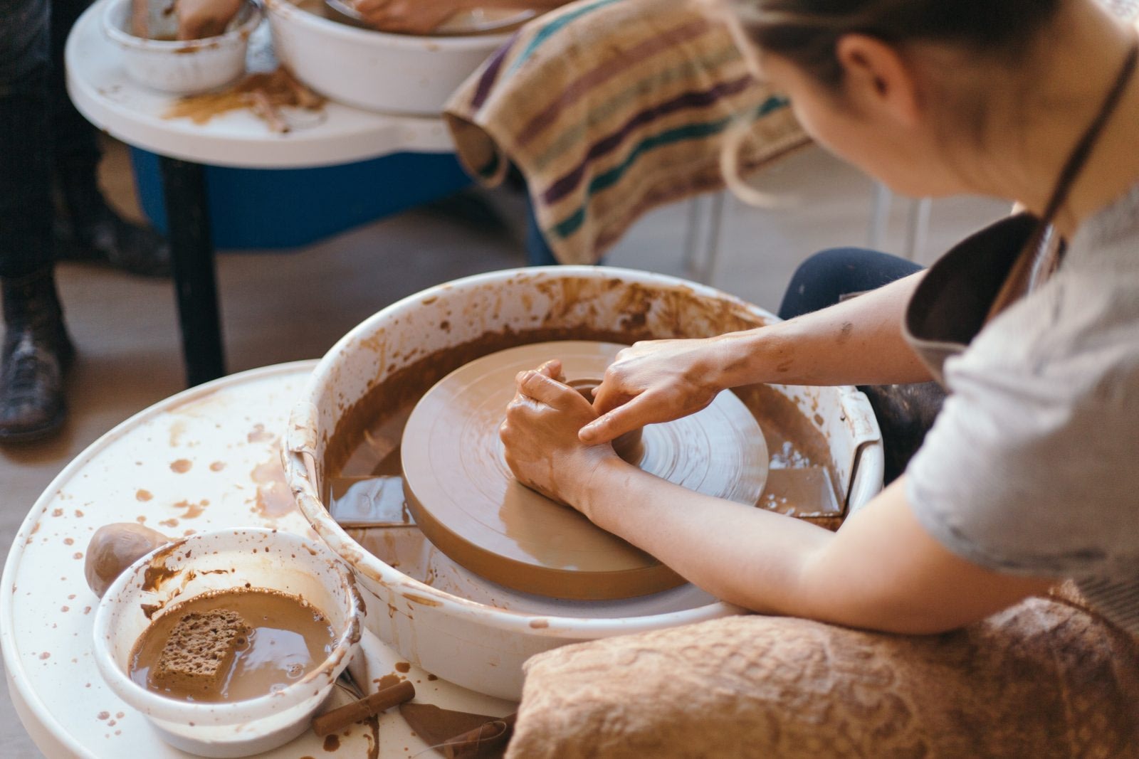 Woman engaging in forming pottery