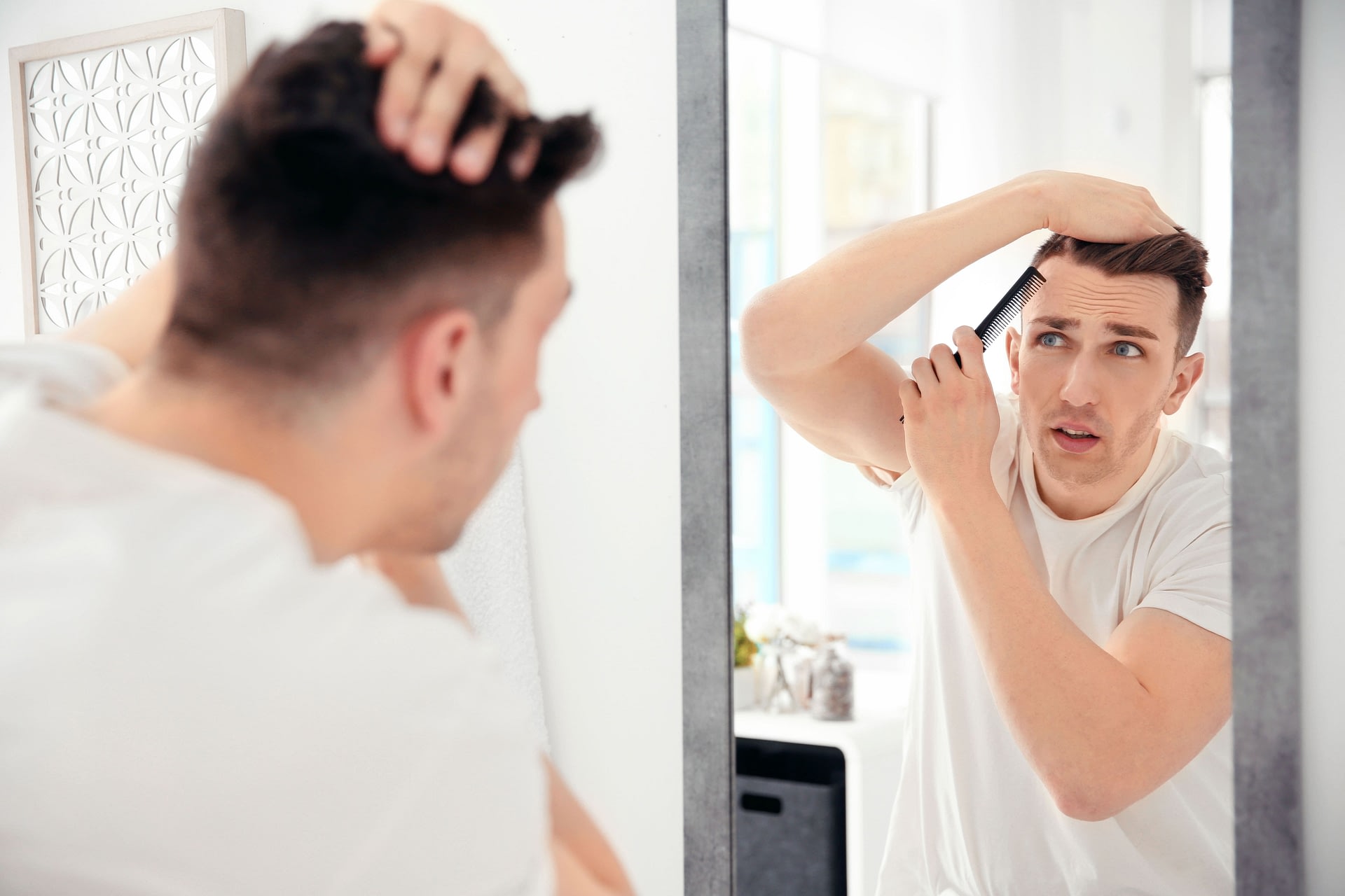 Man combing hair to prevent hair loss