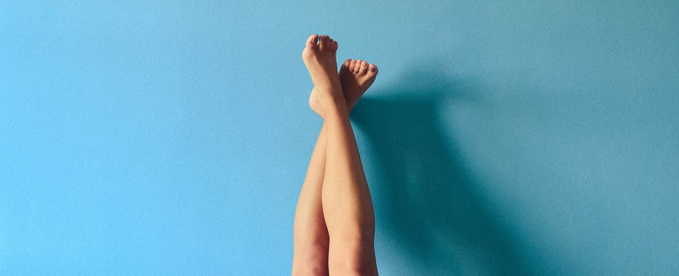 A woman's legs stretched out with one foot over the other