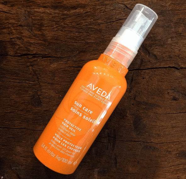 A small spray bottle of Aveda sun care protective hair veil