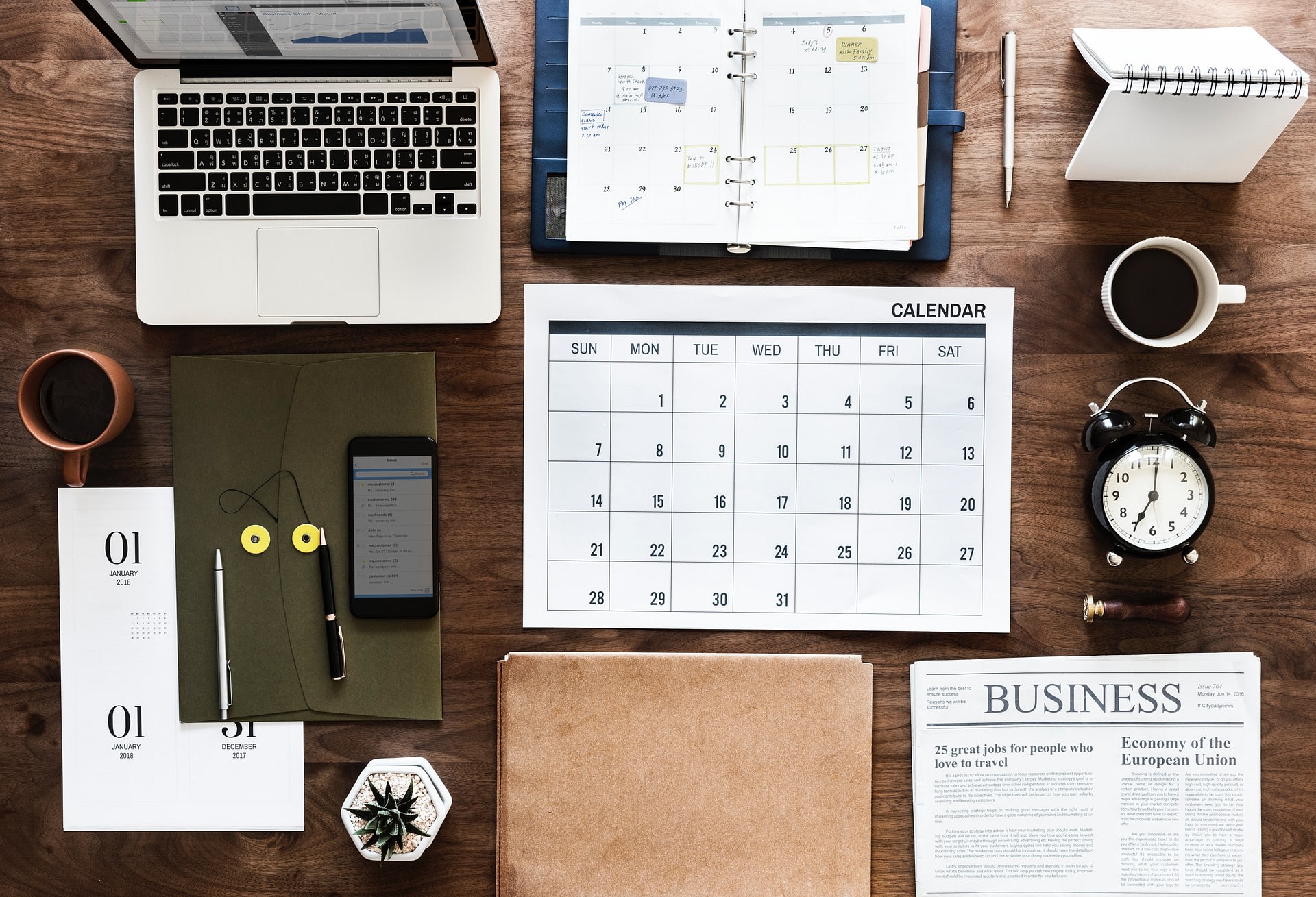 A variety of time management tools organized on an office desk