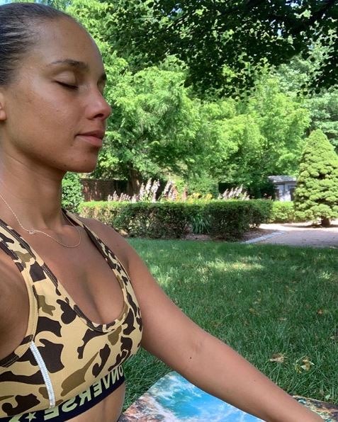 Alicia Keys meditates peacefully outdoors without makeup