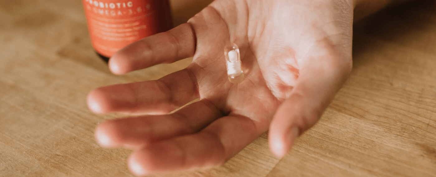An open hand holding a probiotic pill