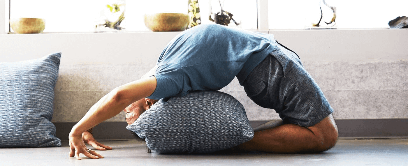 Man doing yoga back bend inside