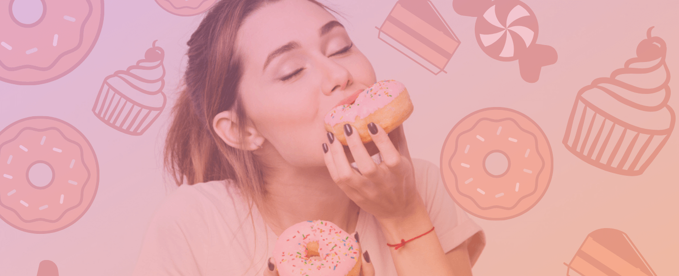 Young girl enjoying a bite of a strawberry frosted donut