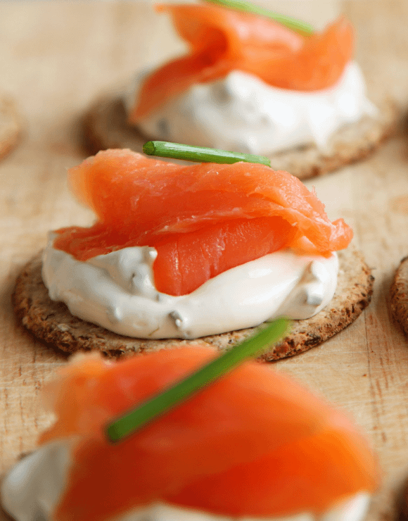 Smoked salmon and cream cheese on a cracker