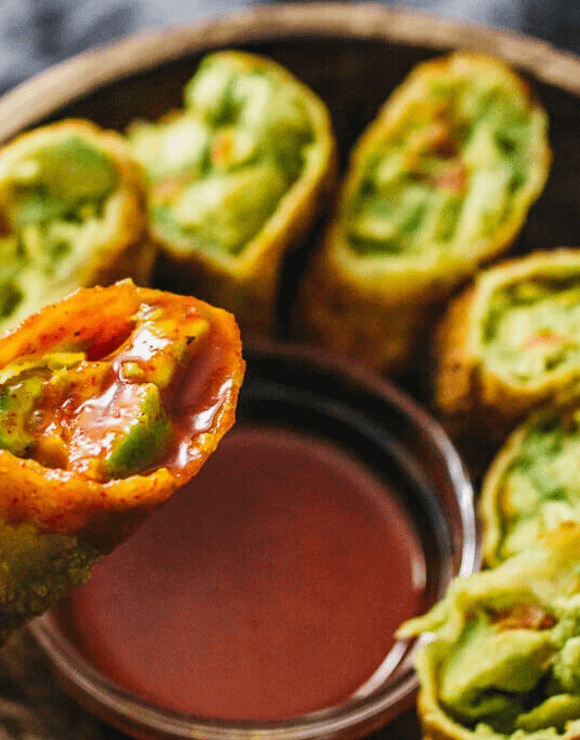 A plate of Avocado Egg Rolls with Sweet Chili dipping sauce