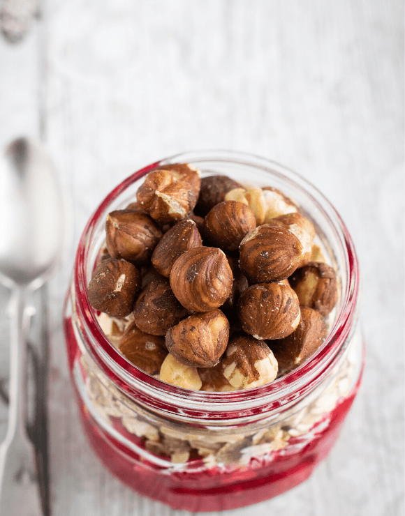 Glass jar filled to the brim with hazelnuts