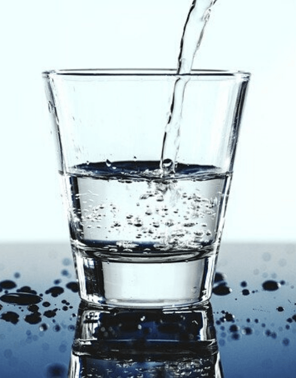 water pouring into a glass to help promote respiratory health