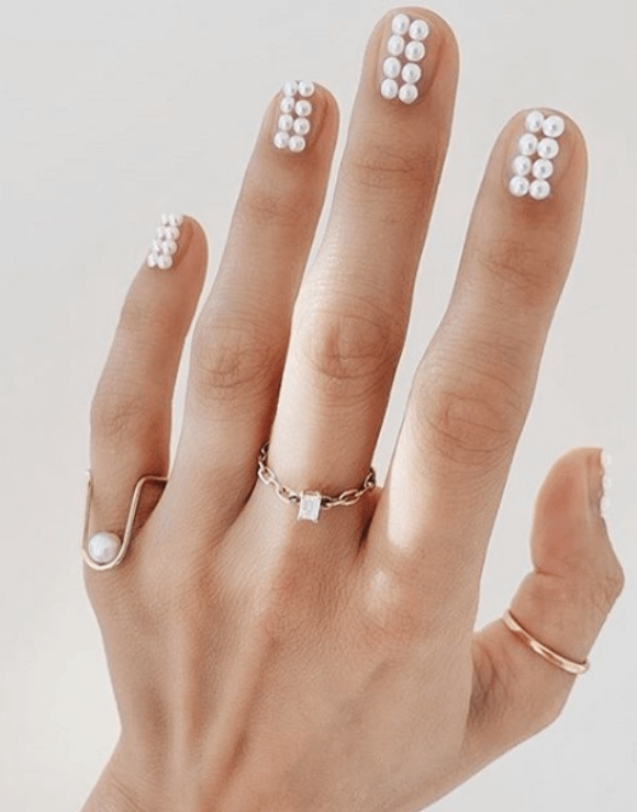 manicured nails with little pearls on each nail