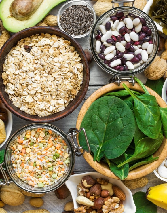 A variety of healthy foods rich in magnesium such as oats, beans, and spinach