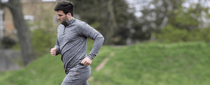 man in grey workout clothes running