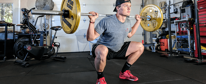 Young male lifting weights in the gym