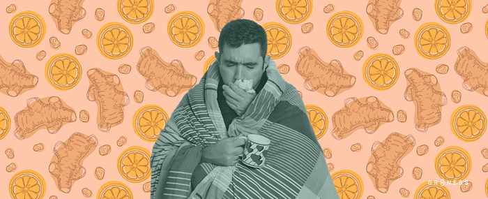 A man wrapped in a blanket coughing up phlegm into a tissue
