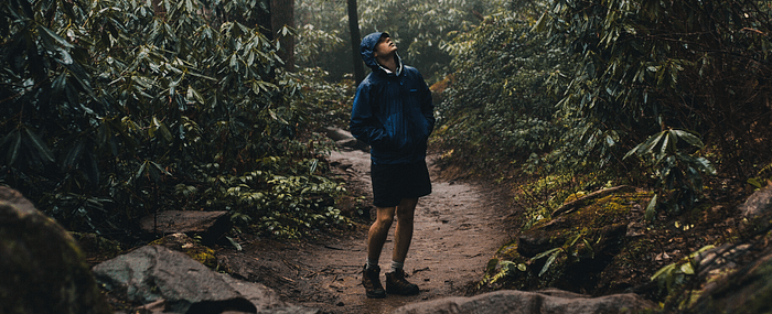 man hiking through rain-forest for fresh air