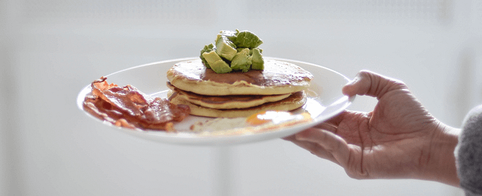 A plate of keto pancakes with avocado on top