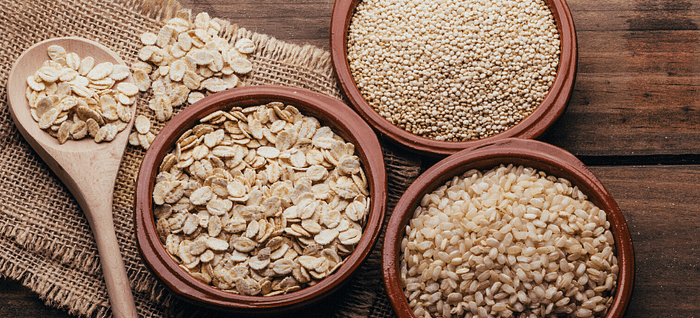 Bowls of oats, quinoa, and grains that help speed up digestion and improve gut health