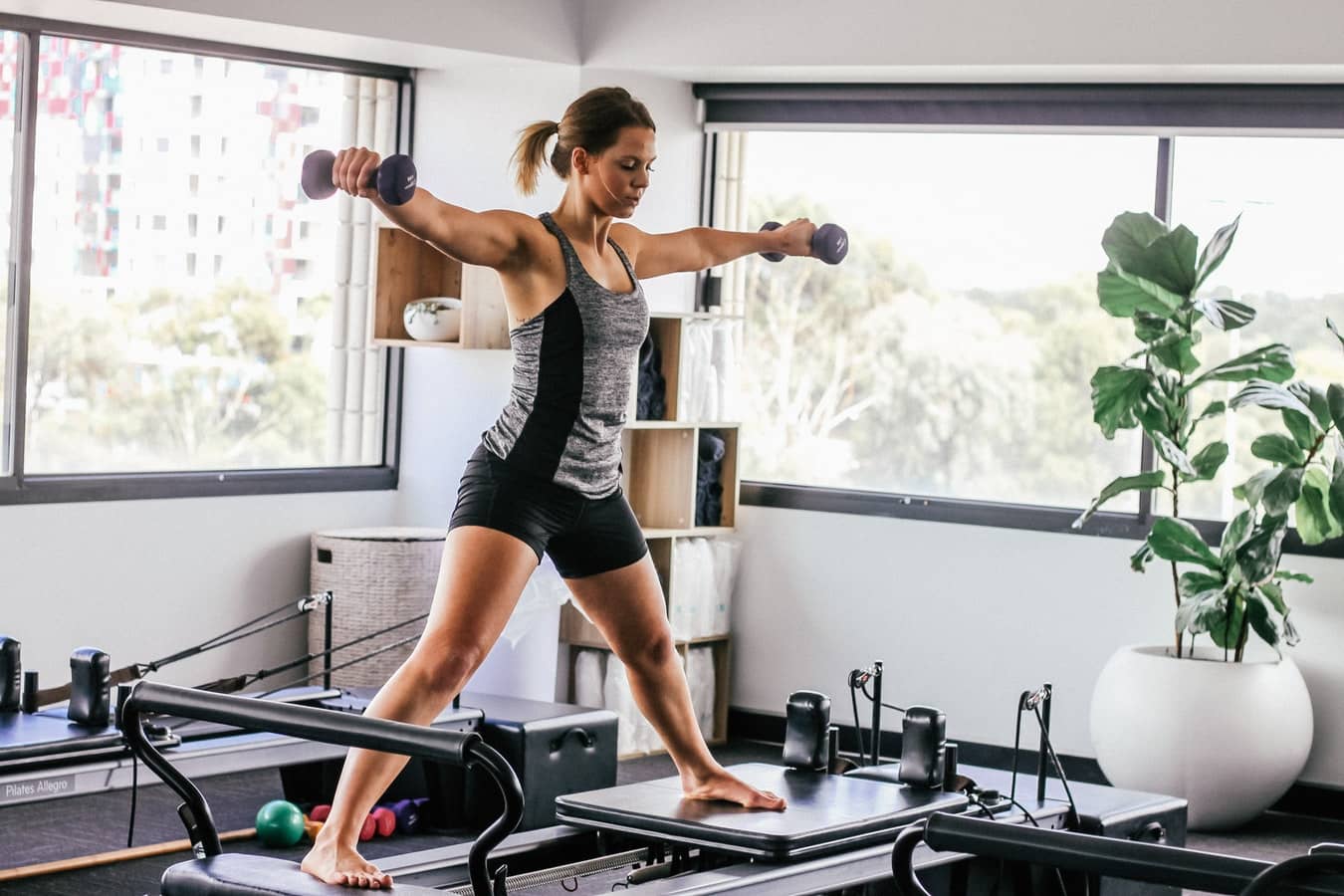 woman using trendy fitness equipment in her home
