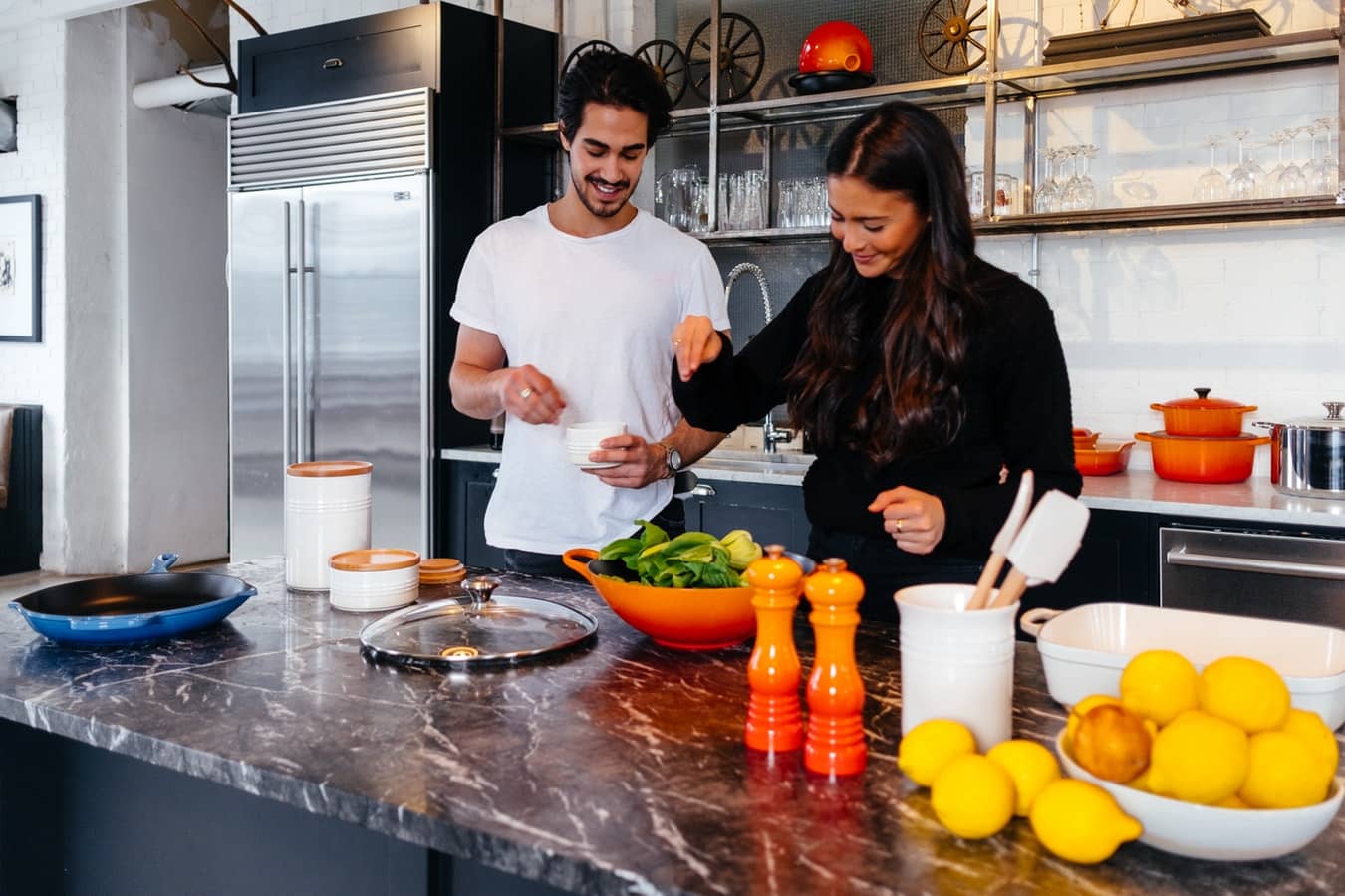 couple making meal together as part of weight loss habits
