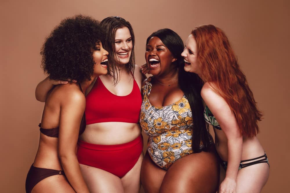 woman of different body types laughing together while discussing the best diet for their body type