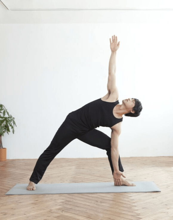 man practicing the Trikonasana yoga pose
