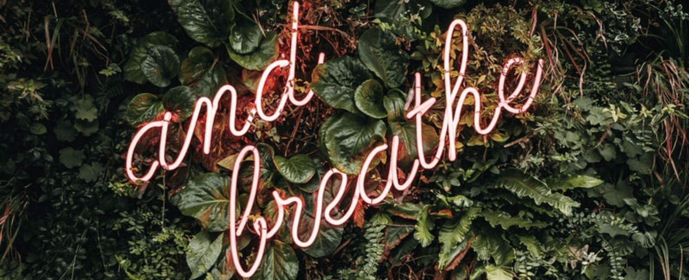 a neon sign that says breathe to help with breathing and stress