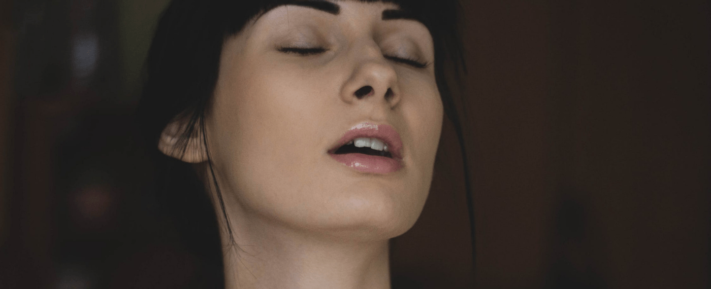 woman ewith eyes closed andmouth open enjoying overcoming being unable to orgasm