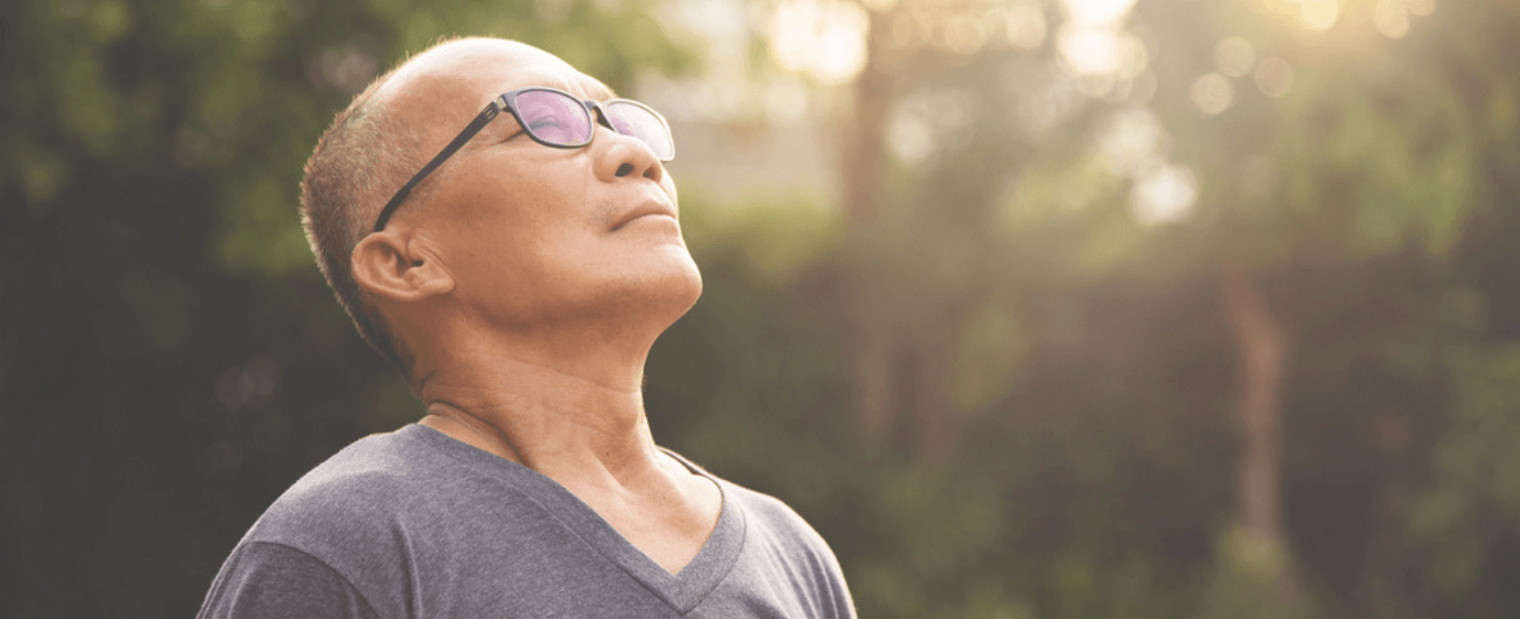 Man breathing in nature, relaxed by his surroundings