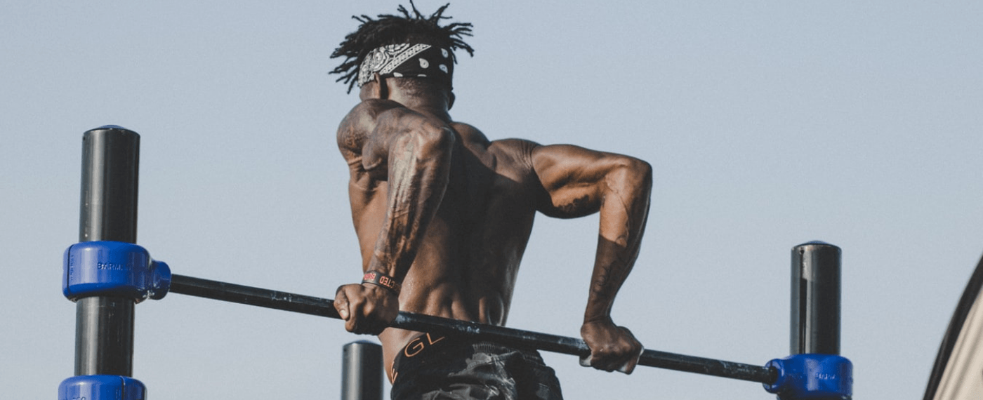 A man working out with outdoor exercise equipment
