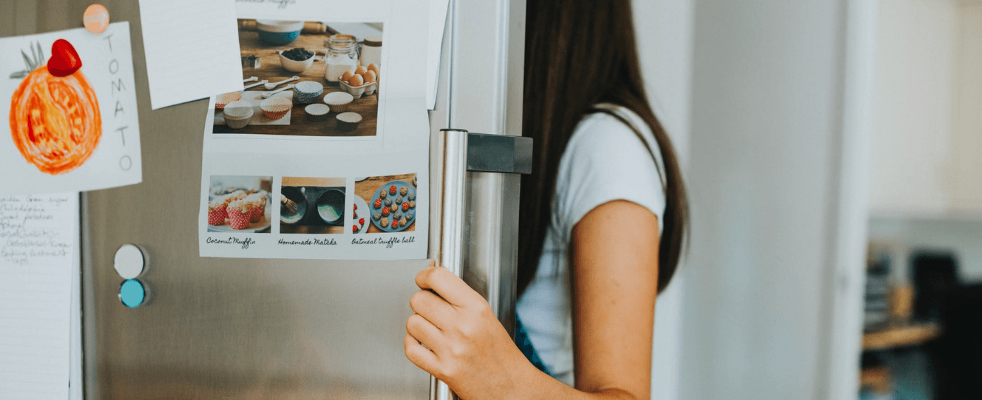 A girl looks into the fridge, looking for her serotonin fix