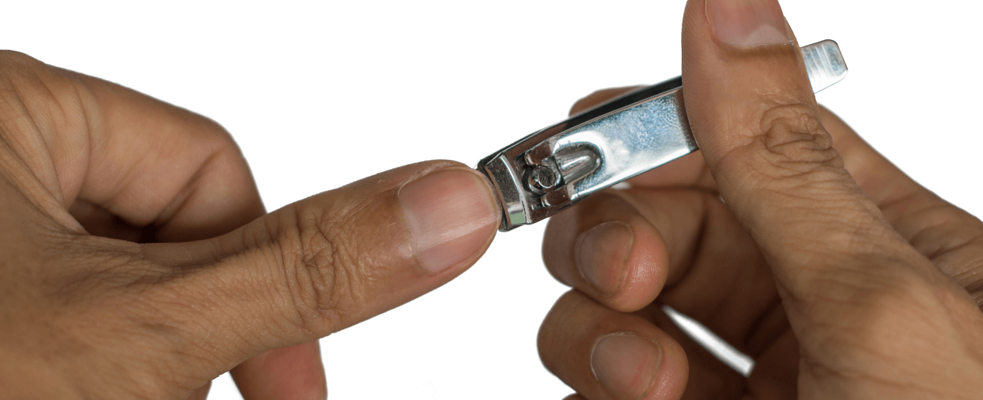 Man cutting fingernails using a nail clipper