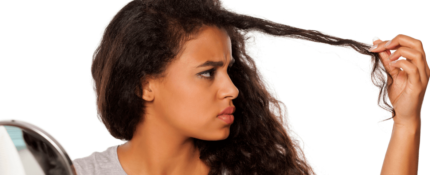 woman holding dried bang trying to repair damaged hair