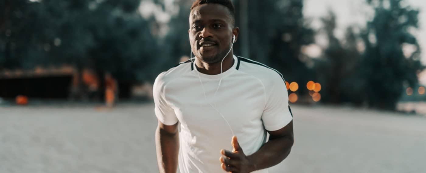 man running with headphones listening to wright loss motivation