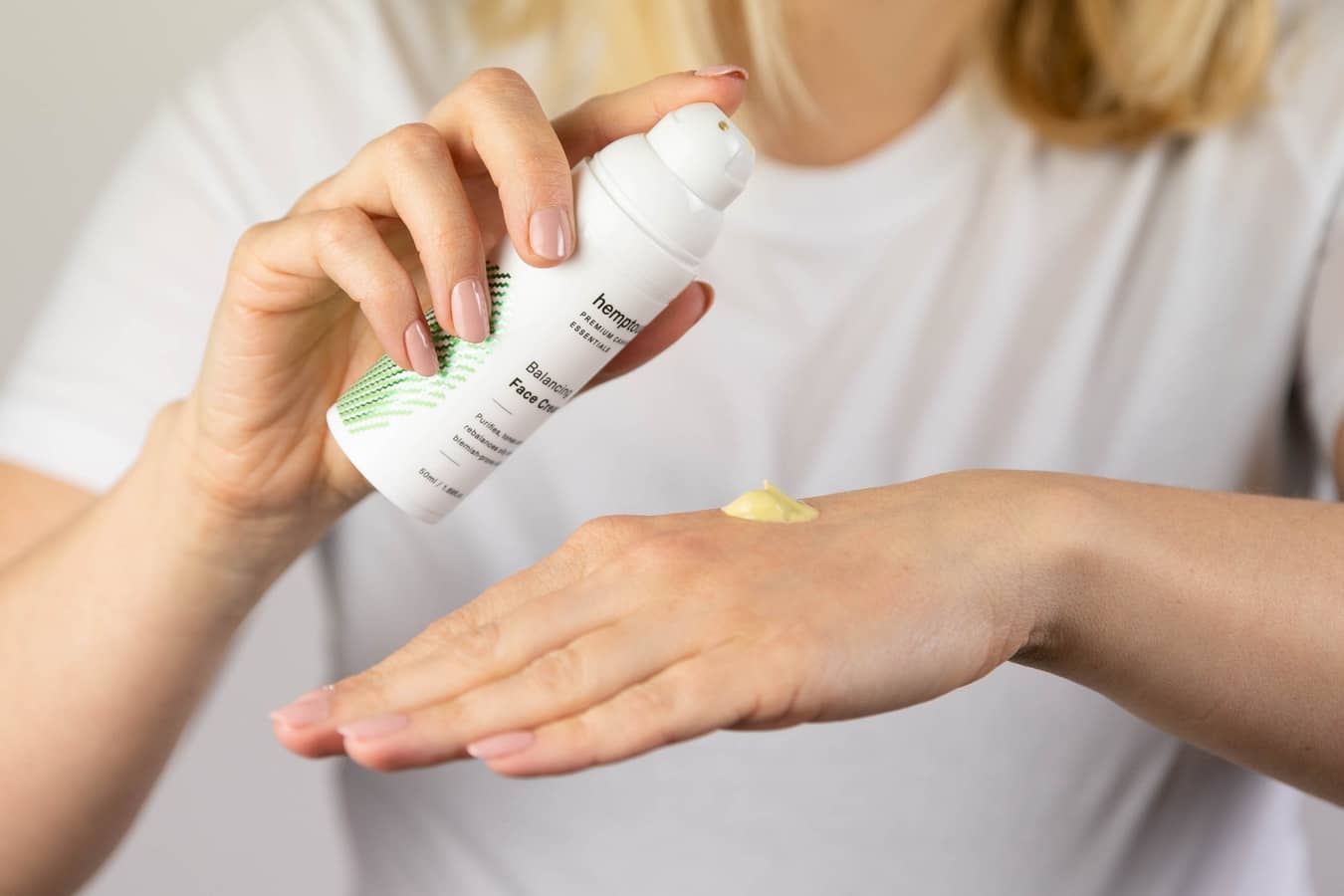 a woman using face serums and creams to create a skincare routine