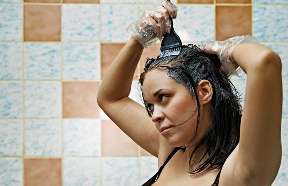 Woman using henna to dye her hair