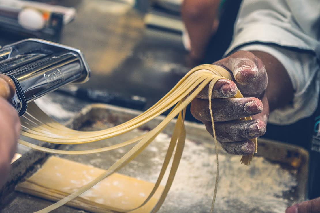 Fresh pasta being created with a pasta maker