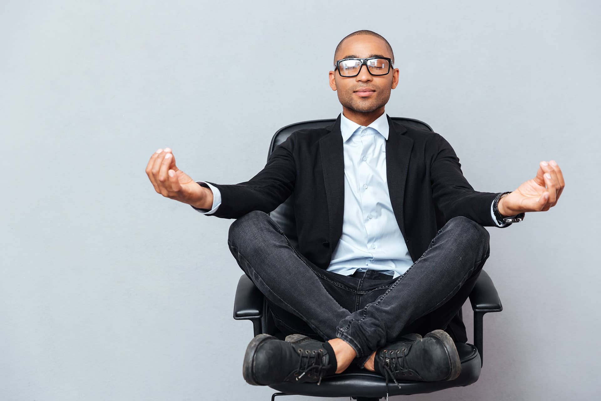 a business man meditation at work in his office chair