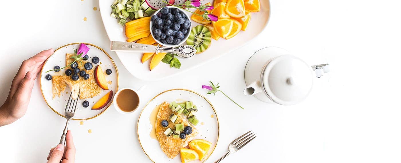 Healthy pancakes with fresh fruit and coffee