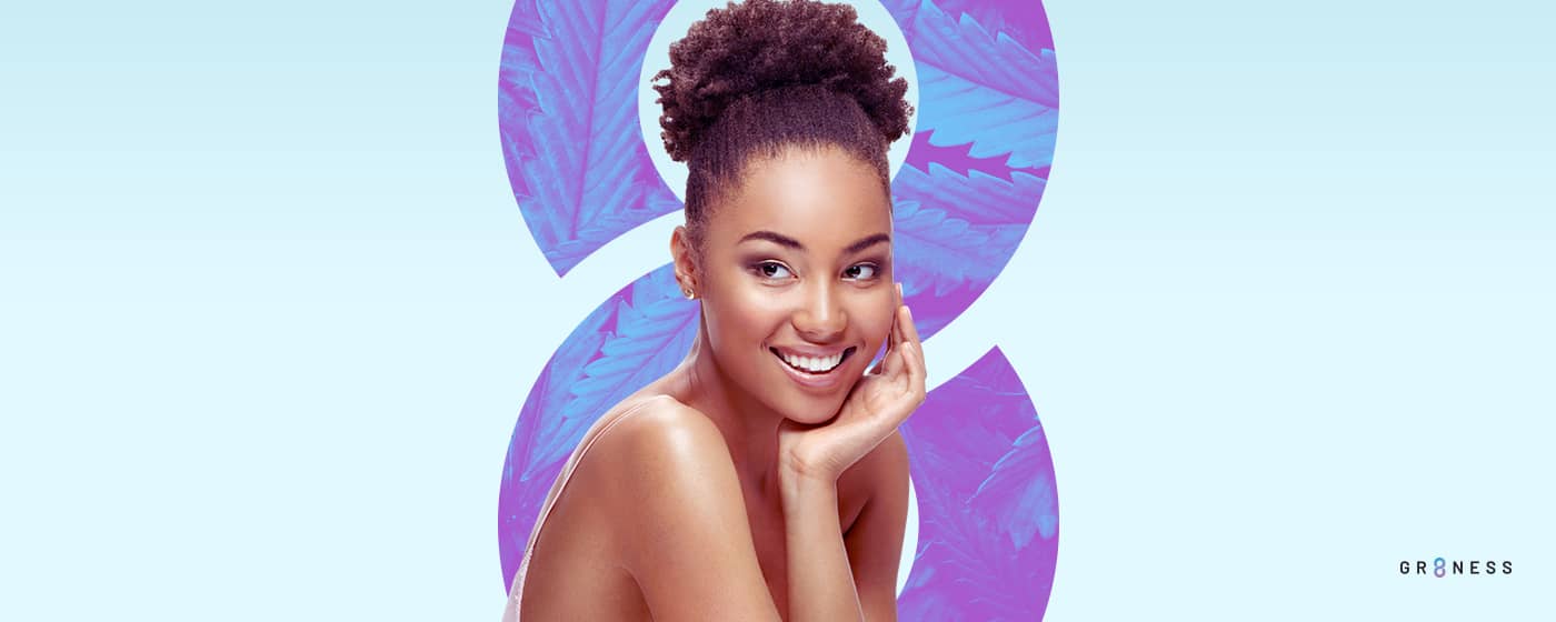 Young girl smiling with hand on cheek promoting skincare