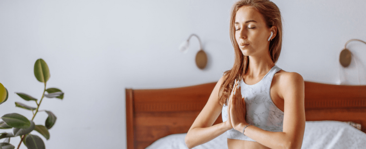 woman practicing mindful meditation in bed
