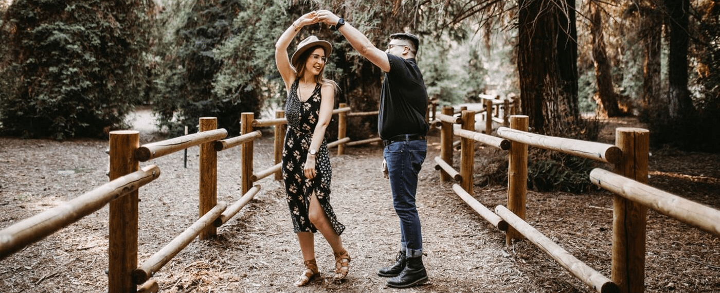 A young couple dances in a natural setting